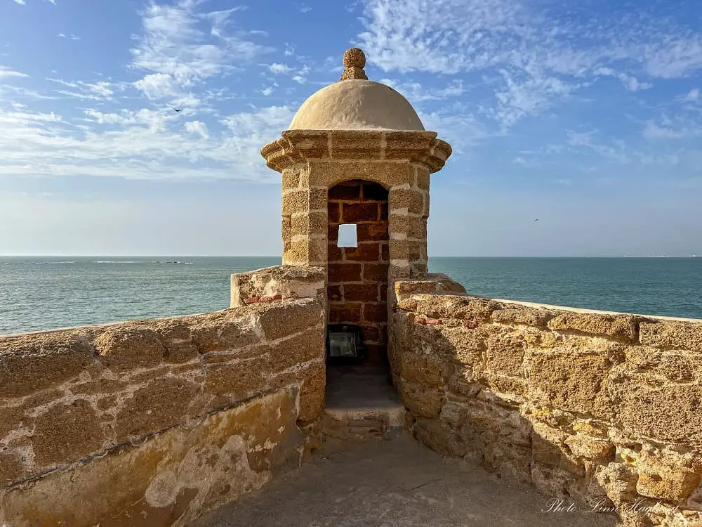 a guard tower jutting out in the sea from Santa Catalina Castle in Cadiz