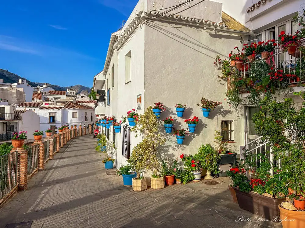 Things to do in Mijas Spain - walk the narrow streets with colorful potplants on the walls.