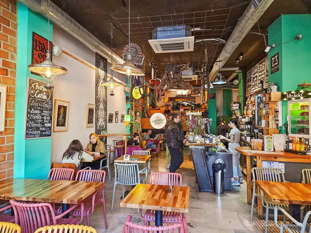 Malaga vegan friendly restaurant with bikes hanging from the ceiling and colorful walls.