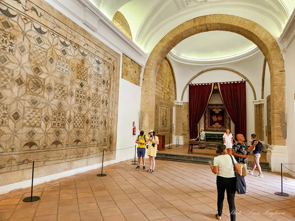 Alcazar Cordoba tickets - tourists looking at mosaic