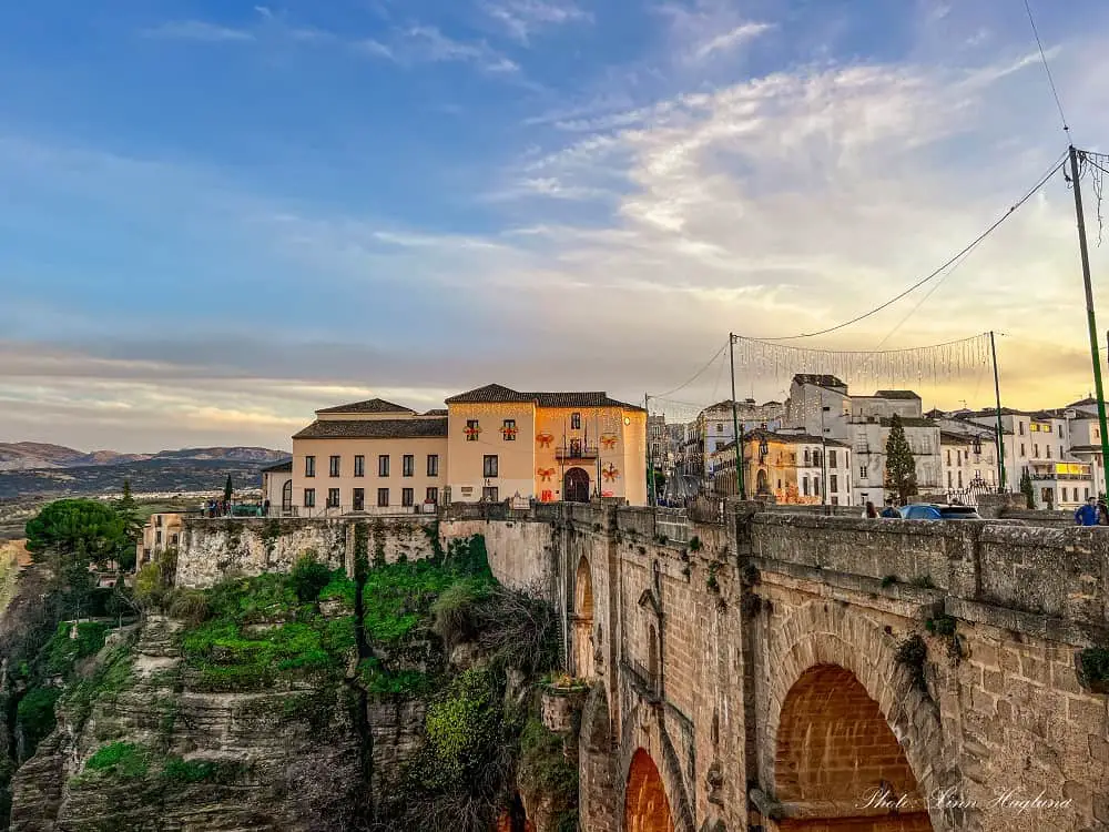 Is Ronda Spain worth visiting? Sunset over the New Bridge connecting the town across the dramatic El Tajo Gorge.