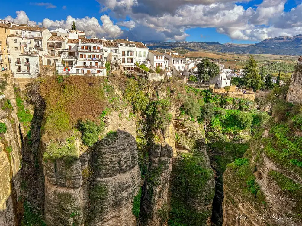 Beautiful views of El Tajo Gorge with green plants growing up the vertical mountins walls is one of the main Ronda toruist attractions