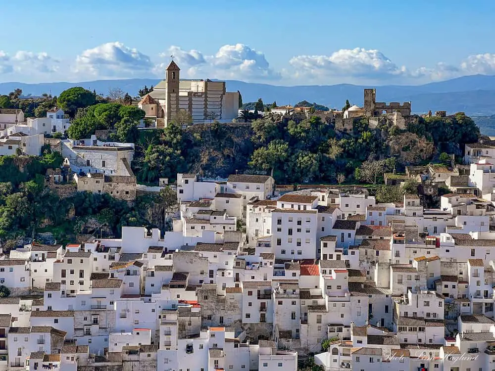 white village near Ronda with a church and old castle overlooking the whitewashed houses cascading down the hill