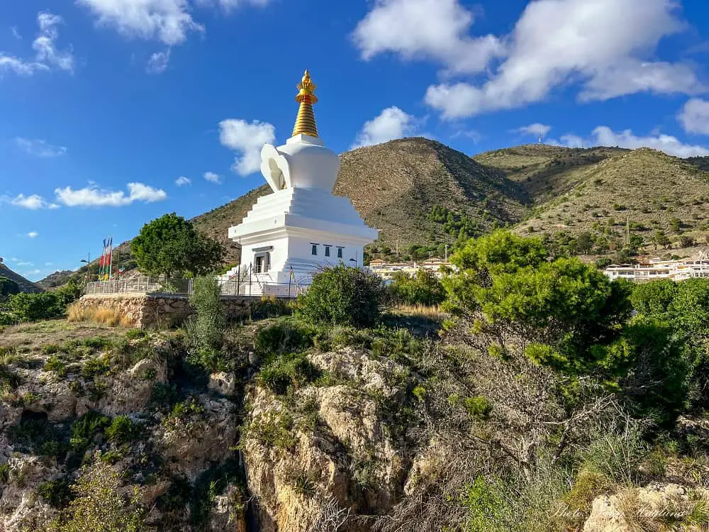 Benalmadena stupa with a backdrop of mountains.