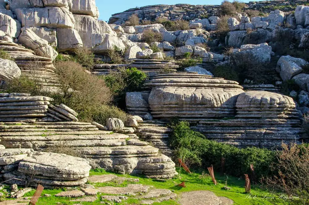 Unique rock formations looking like giant stacked pancakes in El Torcal de Antequera, one of the best places to visit in Andalucia Spain.
