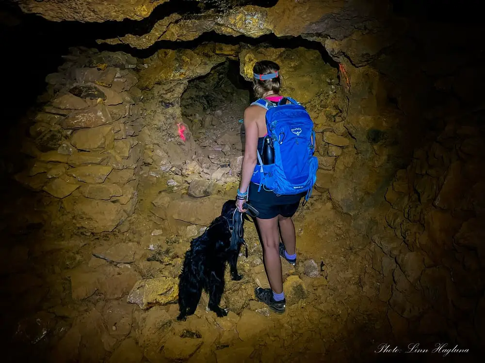 Me and my dog Ayla inside Minas de la Trinidad with a headlamp to see the cave ahead.