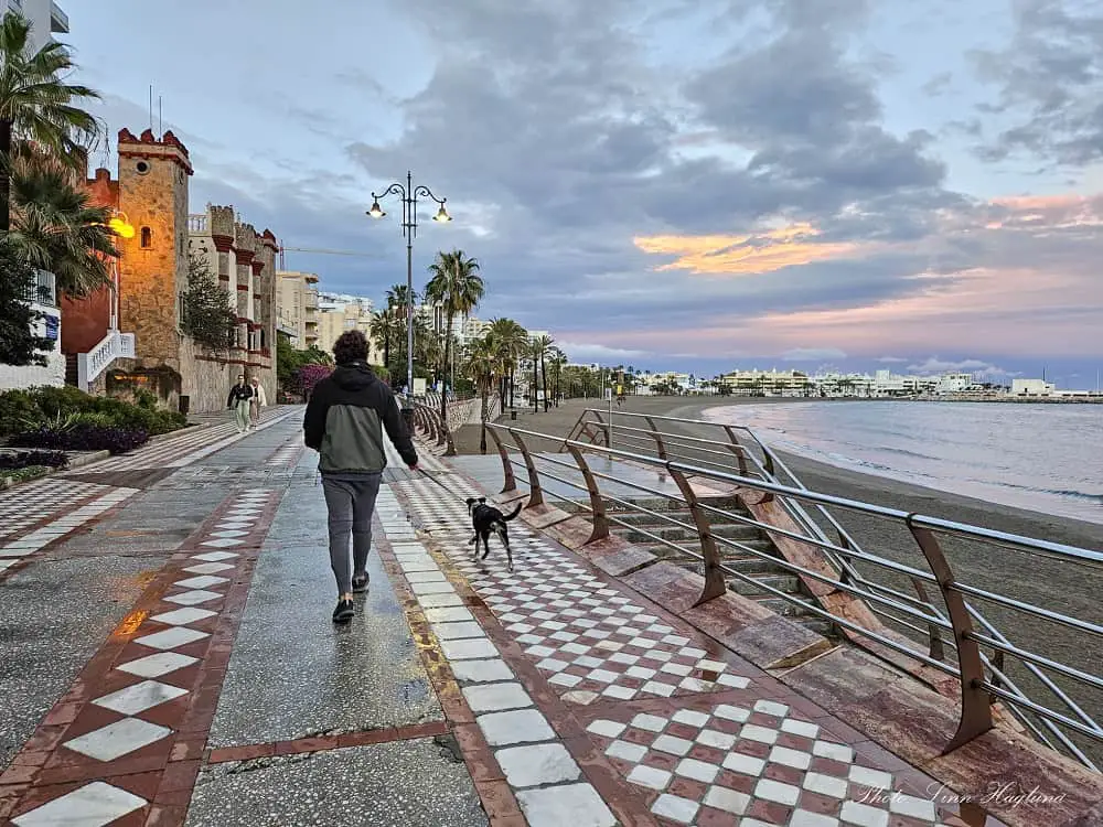 Mohammend and our puppy Atlas walking along the promenade at sunset which is one of the top things to do in Benalmadena.