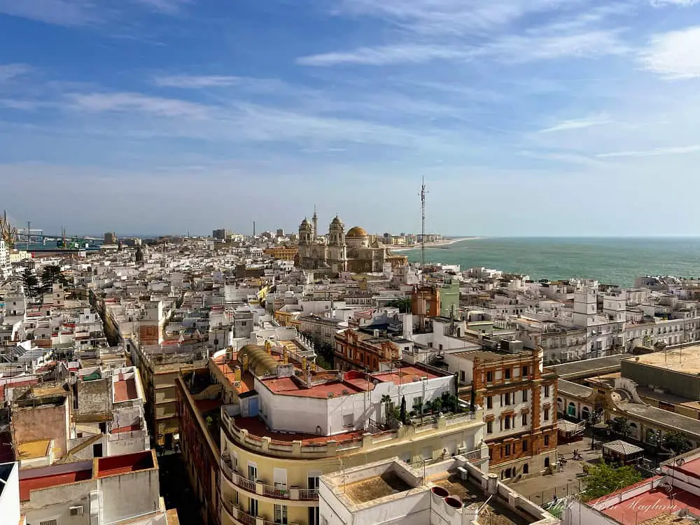 Views of the cathedral, rooftops, and coast in Cadiz seen from the Tavira Tower.