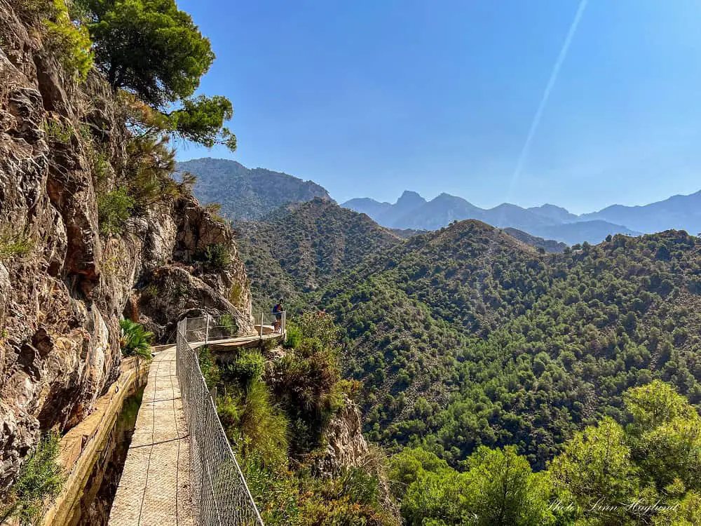 Hiking along the irrigation ditch of Acequia del Lizar Frigiliana with endless views of pine forests.