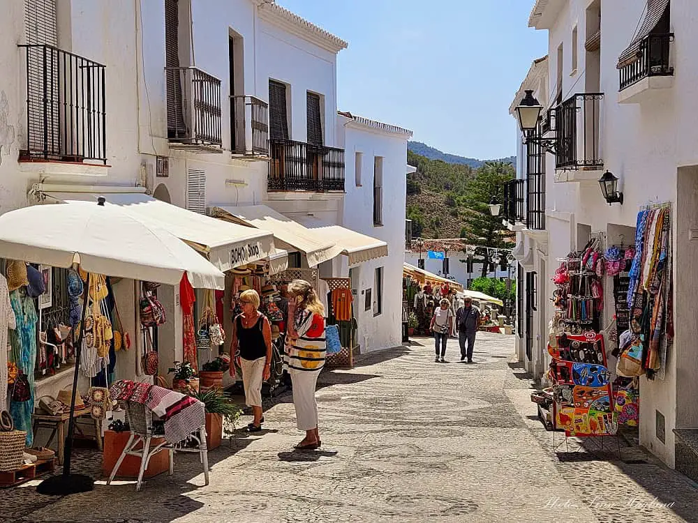 Tourists shopping in the small boutique shops of Frigiliana Spain.