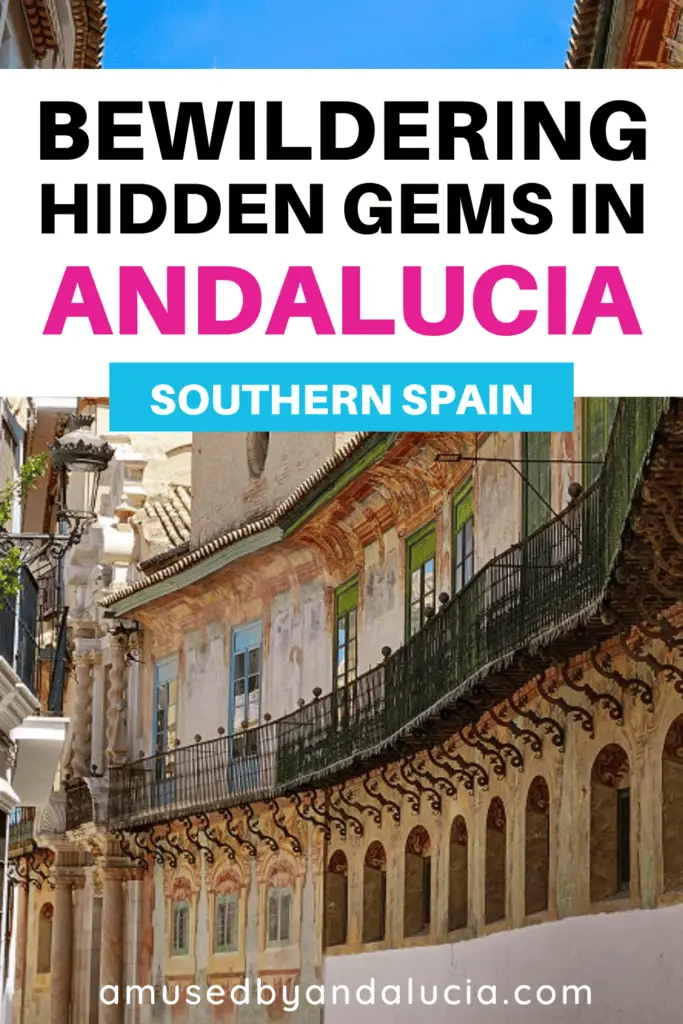 Pinterest image of a painted biulding and the overlay text: "Hidden Gems in Andalucia Spain."