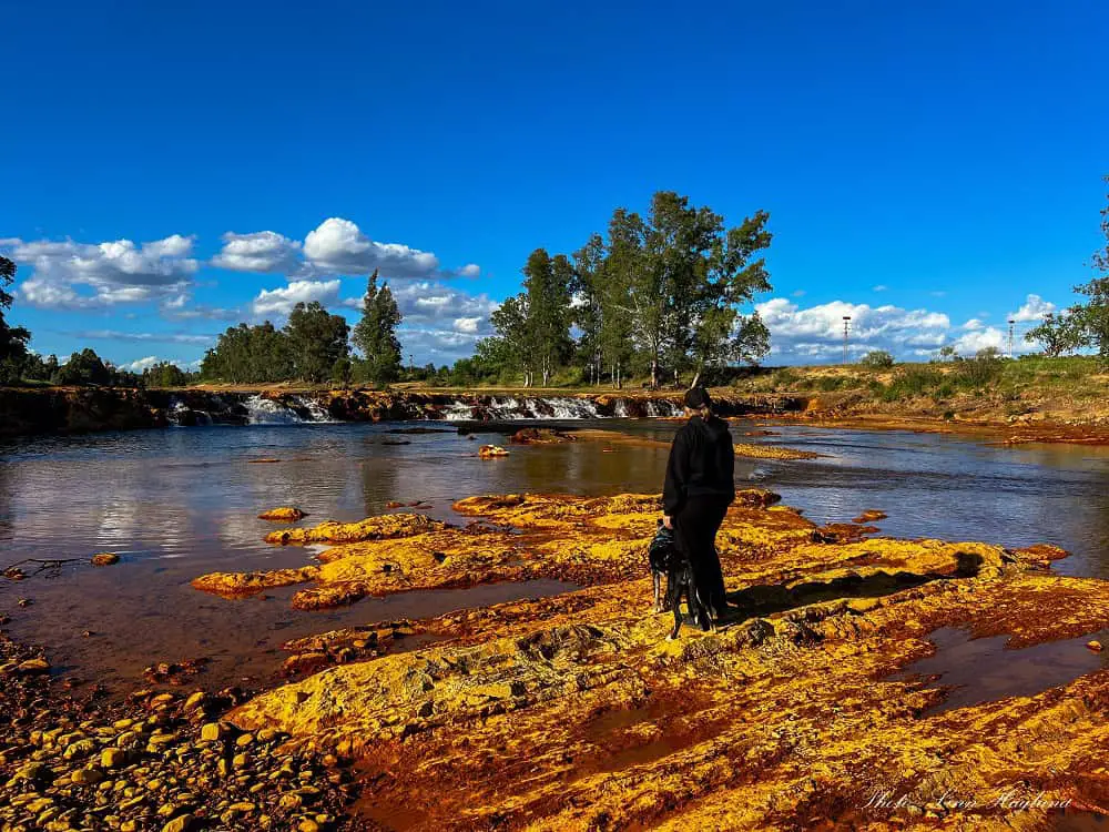 Me and Atlas standing on yellow rocks in the Rio Tinto in Niebla Huelva.