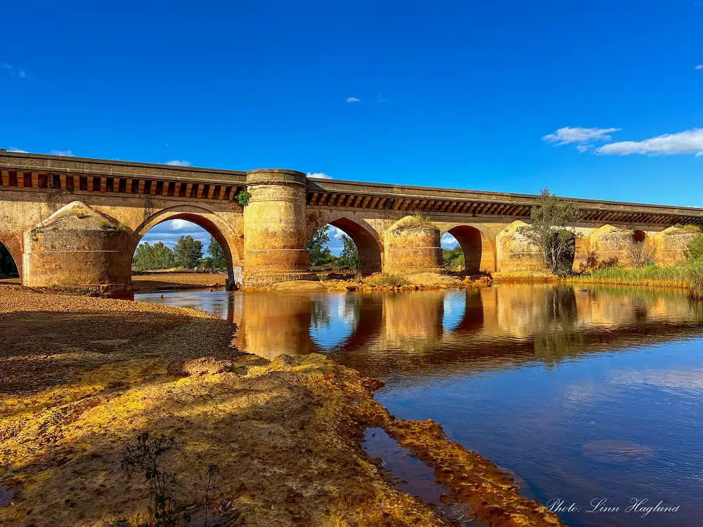 Roman Bridge in Niebla Huelva reflecting in the water.