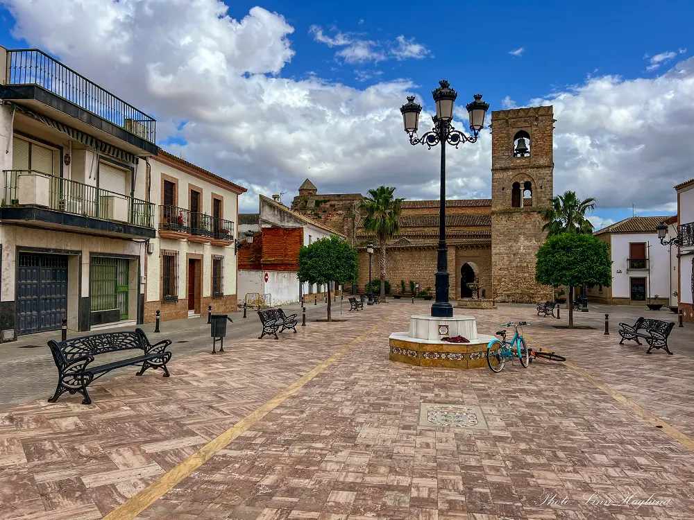 Square in Niebla with a beautiful stone church at the end.