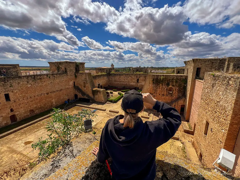 Me visiting Niebla Castle. Overlooking the entire castle is among the best things to do in Niebla Spain!