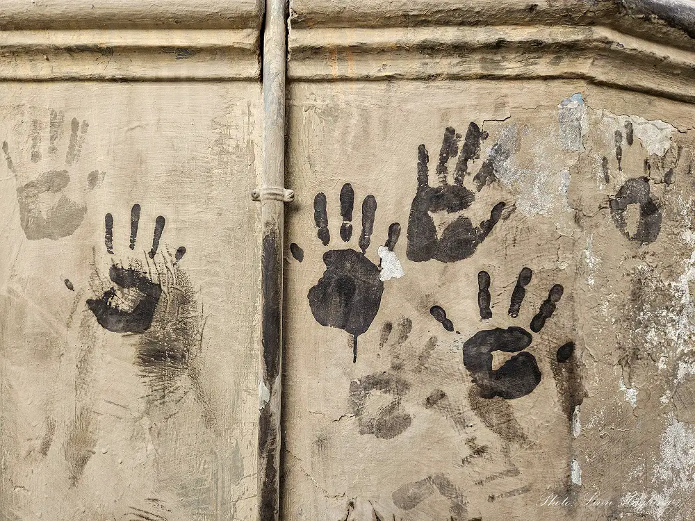 Black hand prints on the wall as a reminder of the Cascamorras Festival in Baza.
